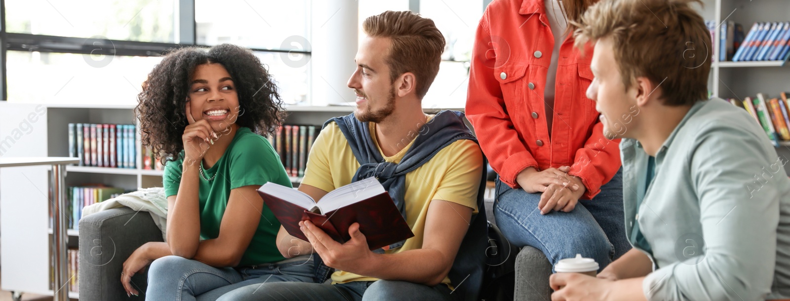 Image of Group of young students at table in library. Banner design