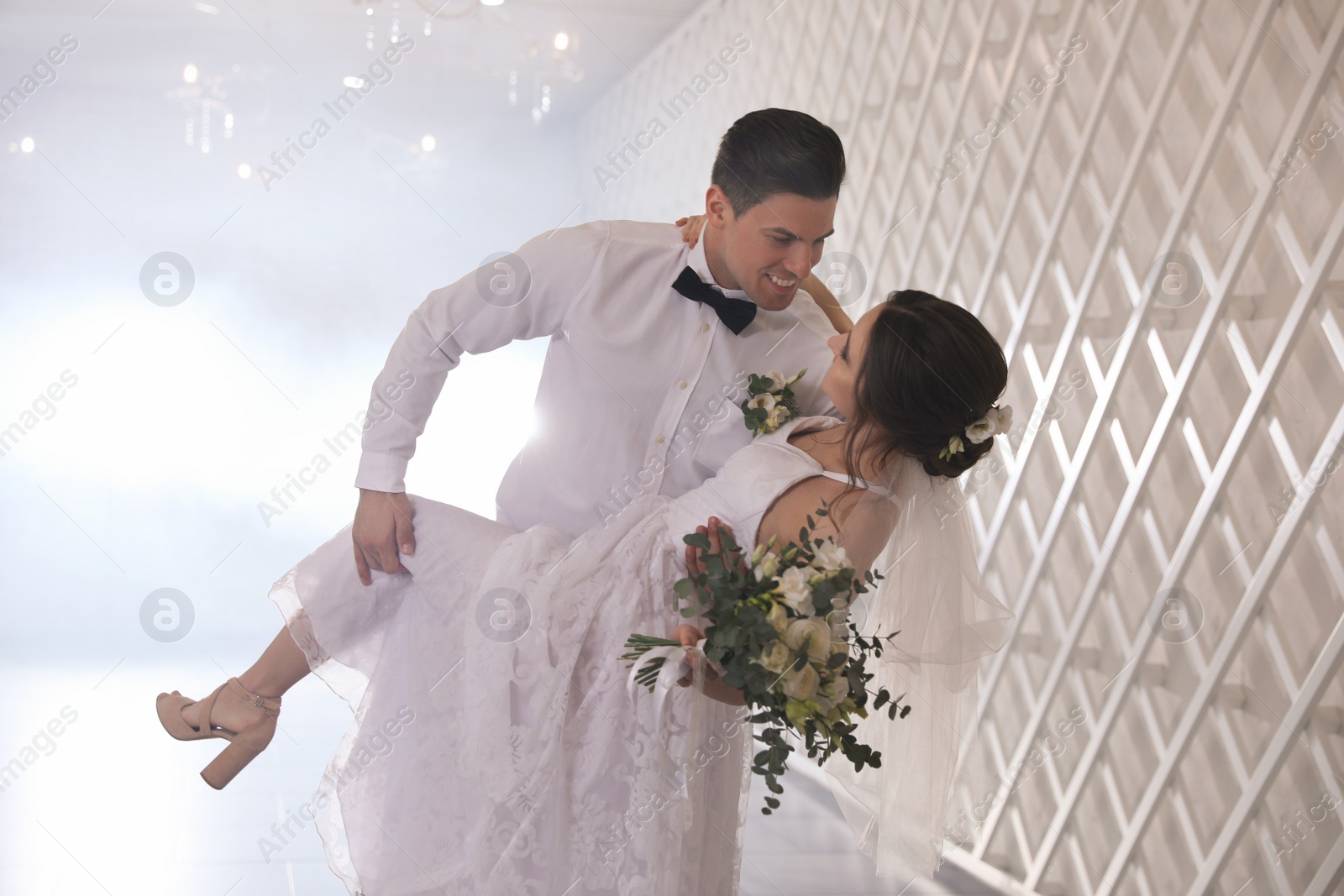 Photo of Happy newlywed couple dancing together in festive hall