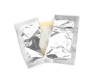 Photo of Torn condom package isolated on white, top view. Safe sex