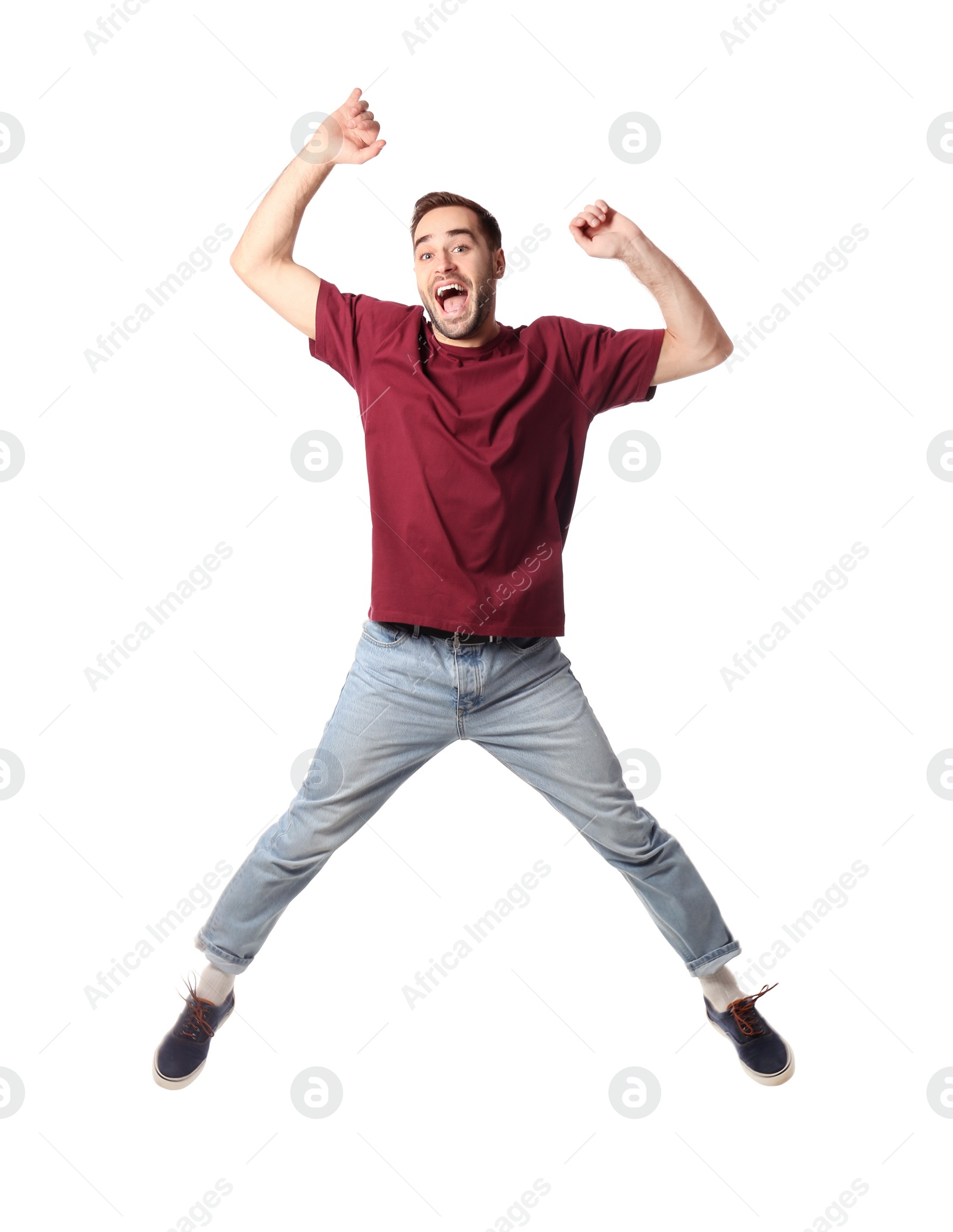 Photo of Full length portrait of happy handsome man jumping on white background