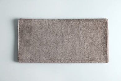 Photo of Fresh fluffy towel on grey background, top view. Mockup for design
