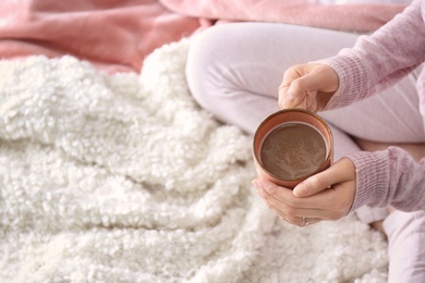 Photo of Morning of young woman with cup of hot coffee at home