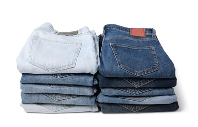 Stacks of different folded jeans isolated on white