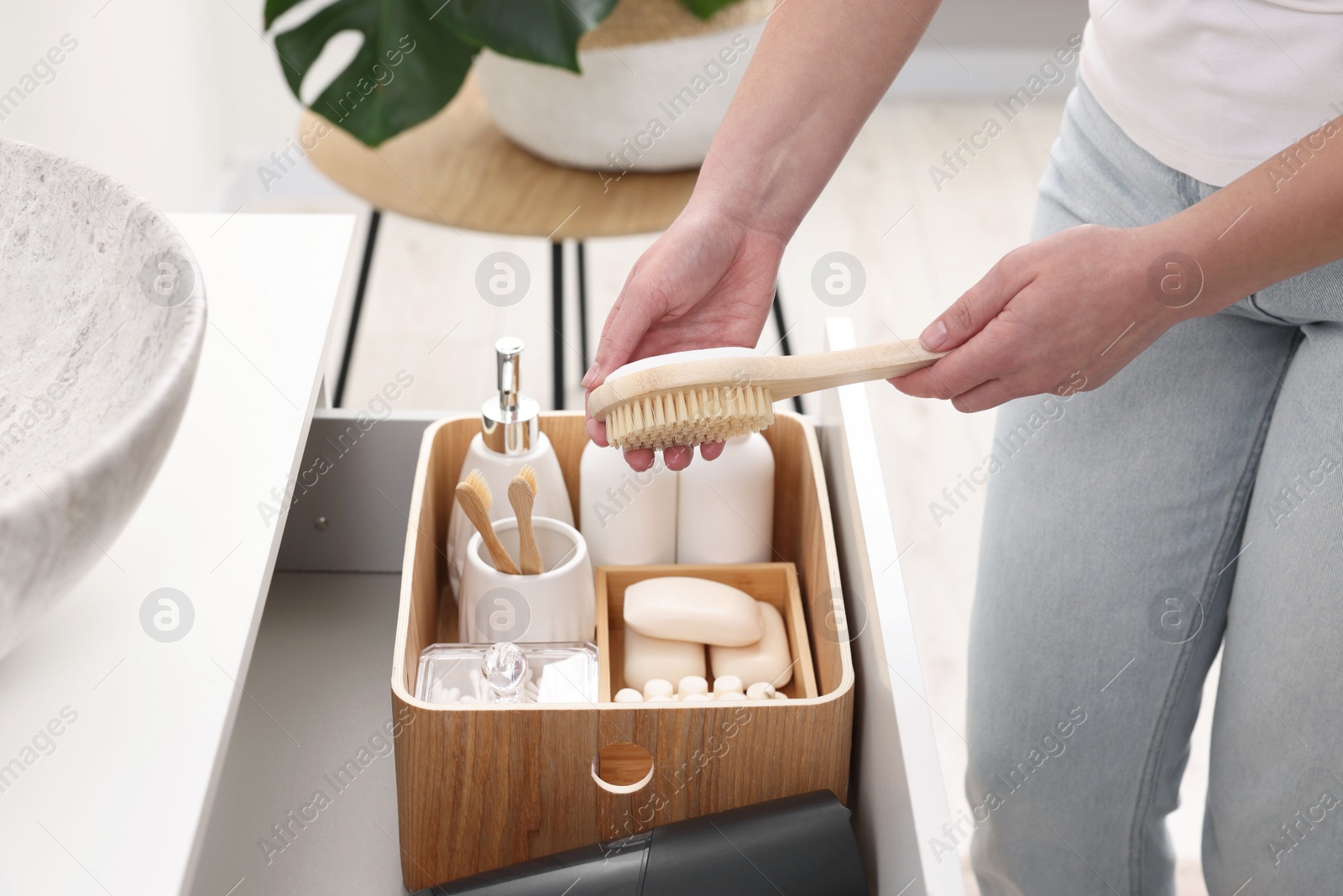 Photo of Bath accessories. Woman organizing personal care products indoors, closeup