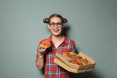 Photo of Attractive young woman with delicious pizza on color background