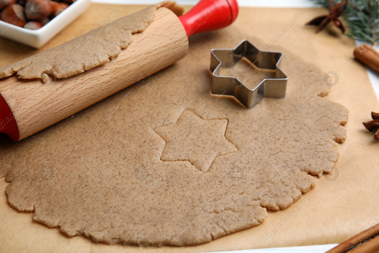 Photo of Homemade Christmas biscuits. Dough, rolling pin and cookie cutter on table, closeup
