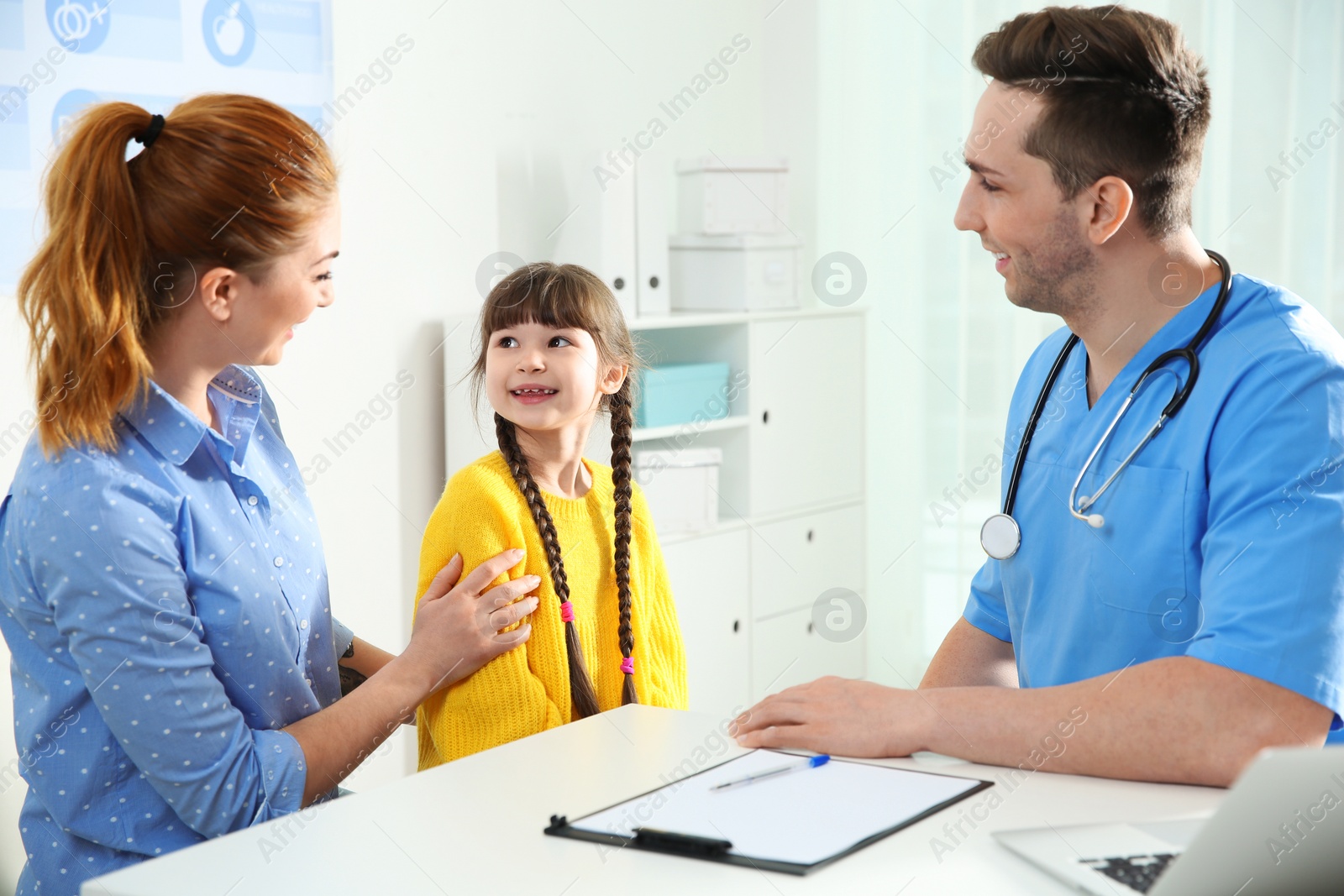 Photo of Mother with child visiting doctor in hospital