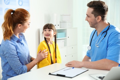 Photo of Mother with child visiting doctor in hospital