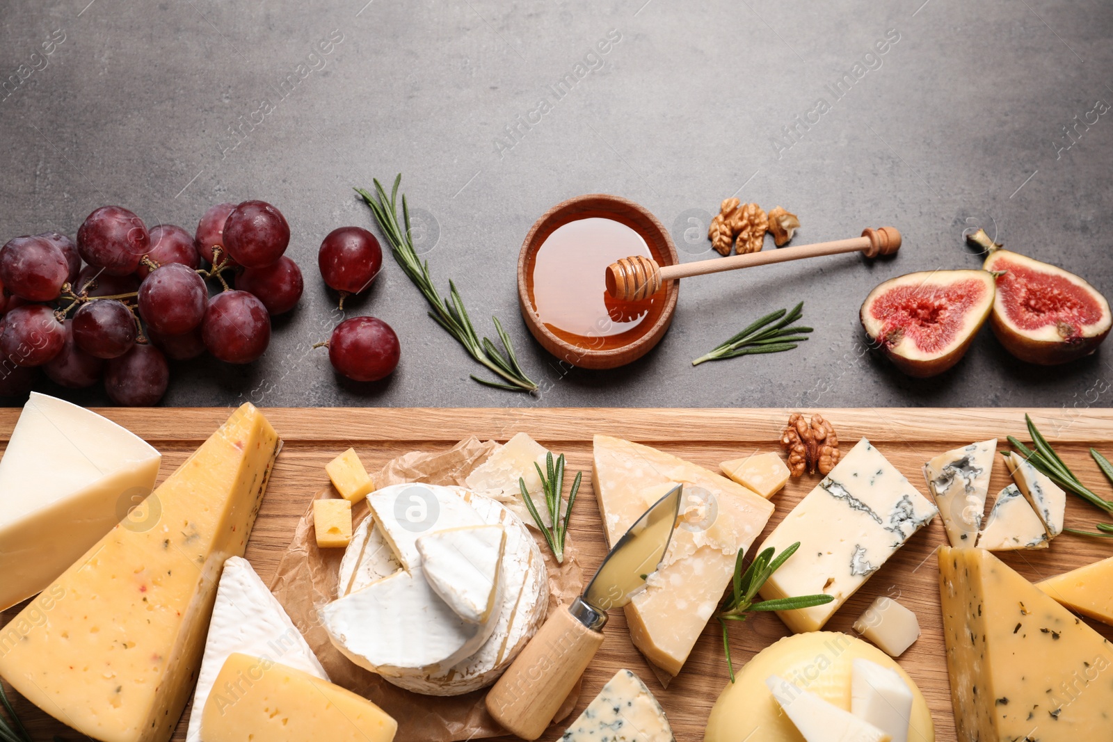 Photo of Flat lay composition with different types of delicious cheese on table