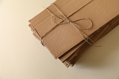 Photo of Stack of waste paper on beige background, closeup