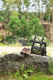 Photo of Set of camping equipment on rock outdoors