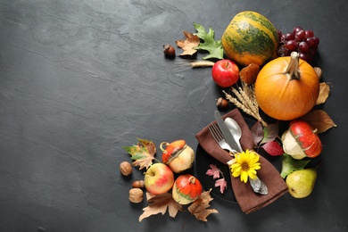 Photo of Autumn fruits, vegetables and cutlery on grey background, flat lay with space for text. Happy Thanksgiving day