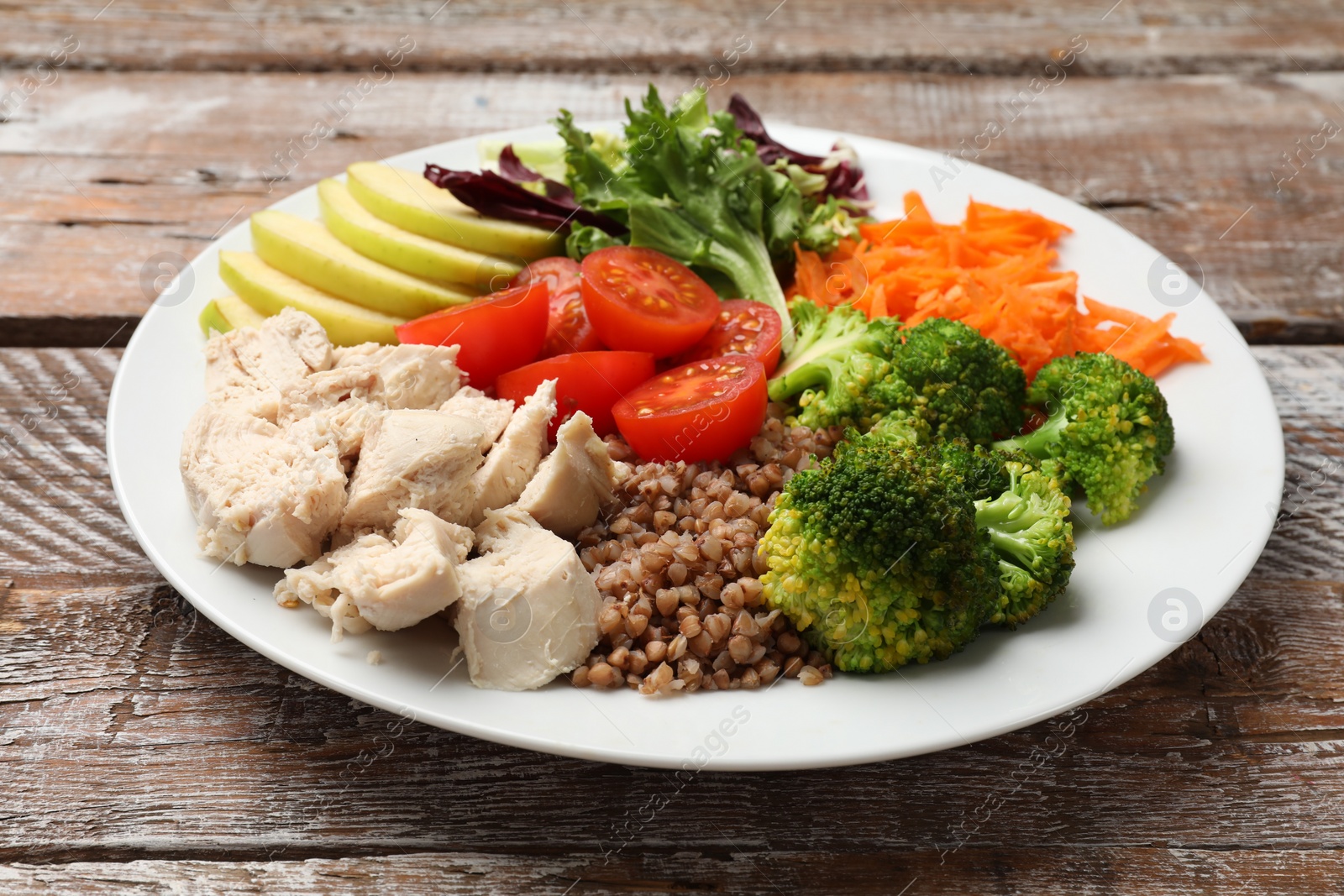 Photo of Balanced diet and healthy foods. Plate with different delicious products on wooden table, closeup