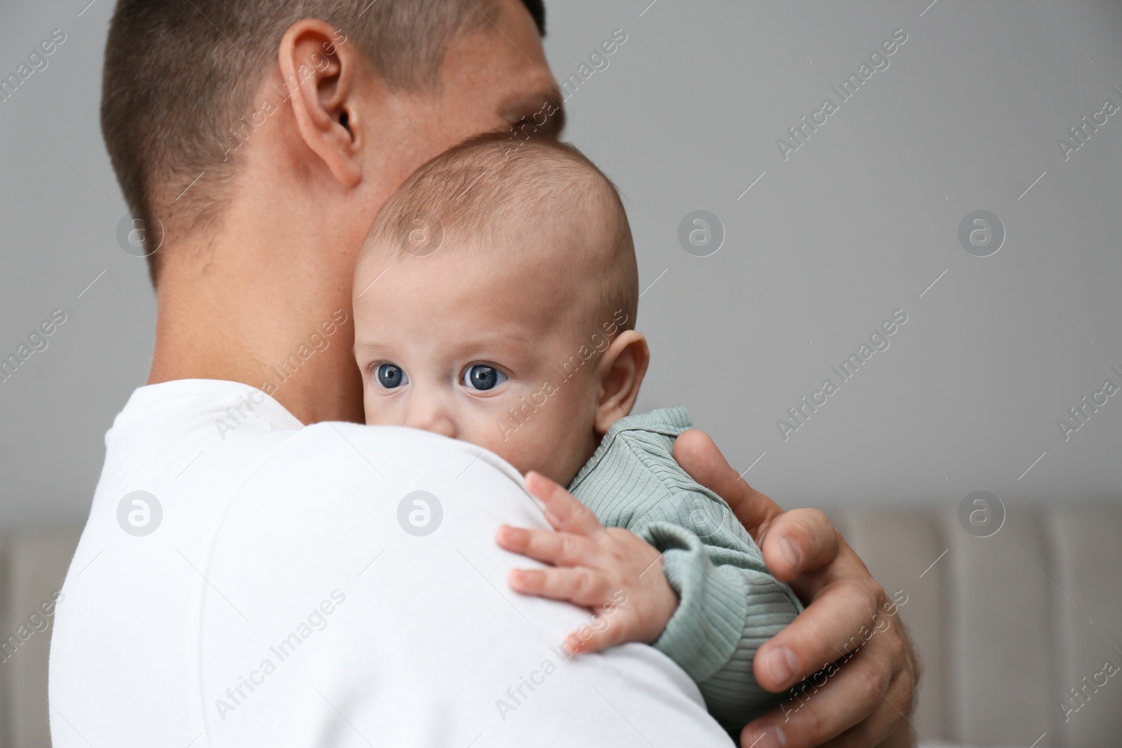 Photo of Father holding his cute baby at home