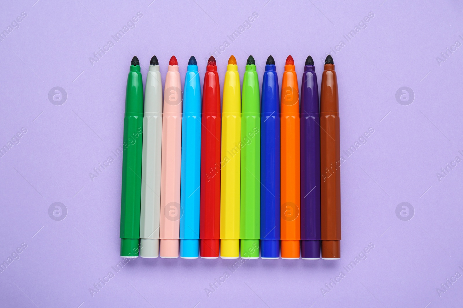 Photo of Different colorful markers on light background, flat lay