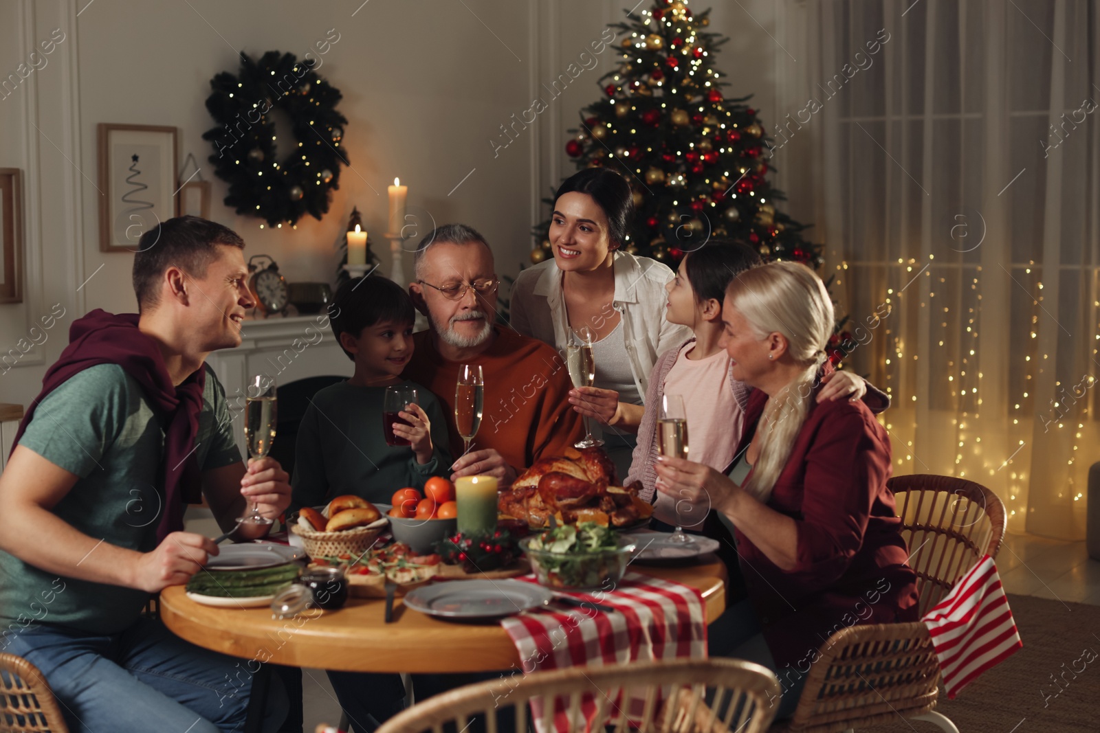 Photo of Happy family enjoying festive dinner at home. Christmas celebration