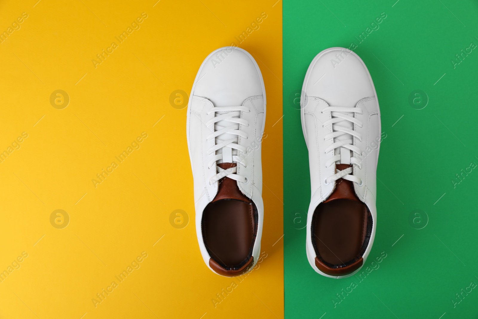 Photo of Pair of stylish sports shoes on color background, flat lay. Space for text