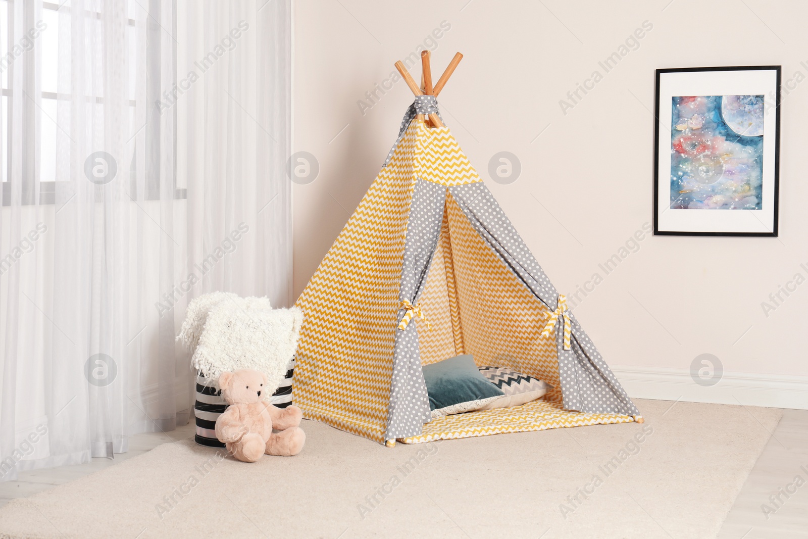 Photo of Cozy child room interior with play tent near window