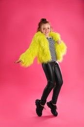 Photo of Full length portrait of cute indie girl on pink background