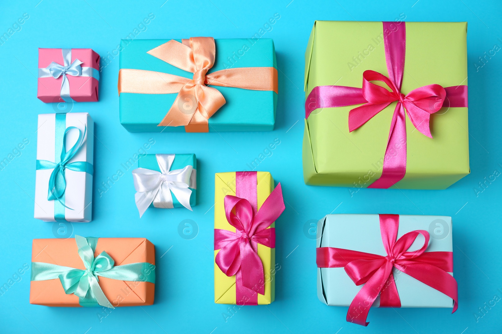 Photo of Flat lay composition with beautiful gift boxes on color background