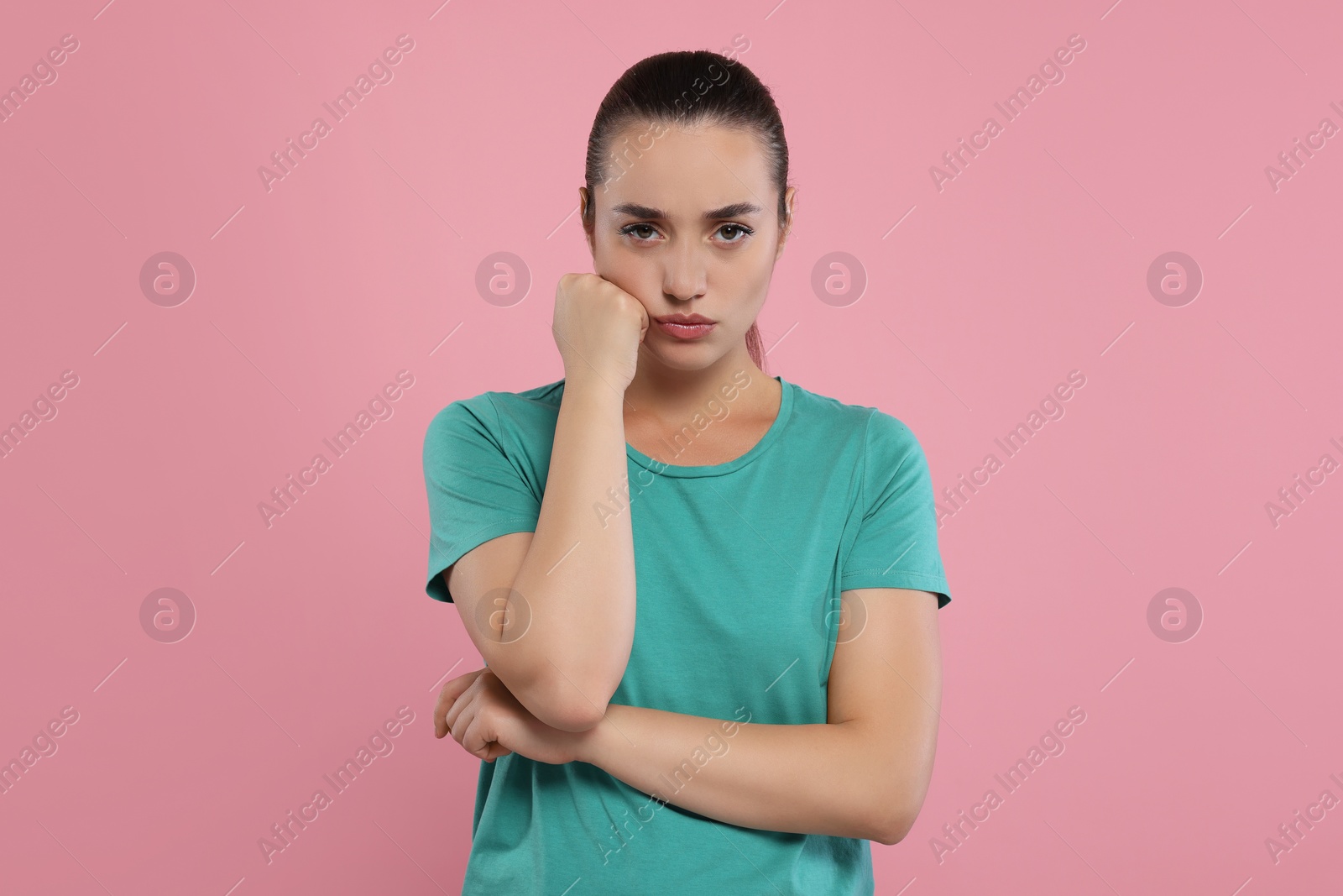 Photo of Portrait of resentful woman on pink background