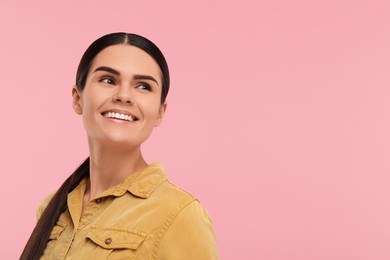 Young woman with clean teeth smiling on pink background, space for text