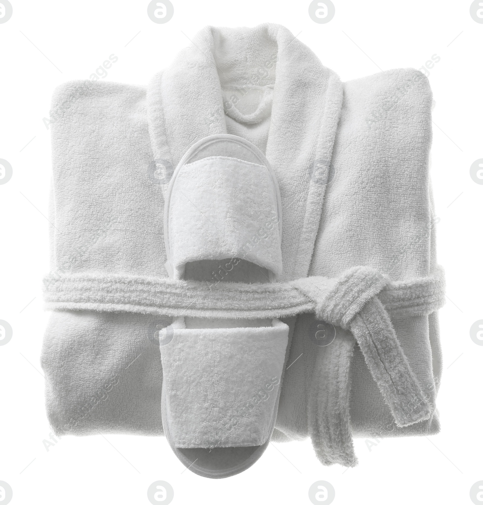 Photo of Clean folded bathrobe and slippers isolated on white, top view