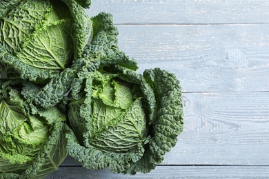 Photo of Fresh green savoy cabbages on grey wooden table, flat lay