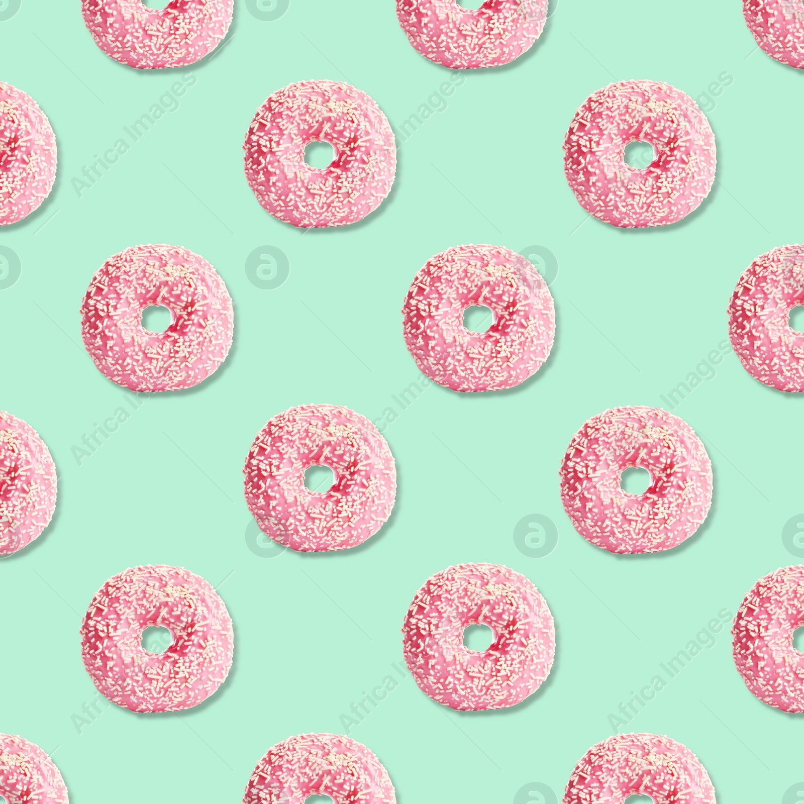 Image of Creative pattern design of glazed donuts on light turquoise background