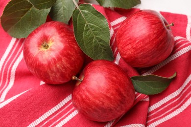 Photo of Fresh red apples with leaves on white table, above view