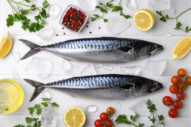 Photo of Raw mackerel, peppercorns and tomatoes on white table, flat lay