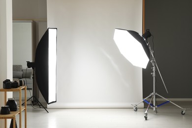 Photo of White photo background and professional lighting equipment in studio