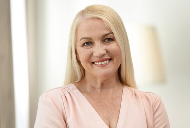 Photo of Portrait of happy mature woman at home