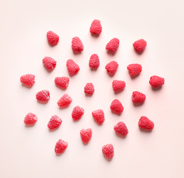 Photo of Fresh sweet ripe raspberries on pink background, flat lay