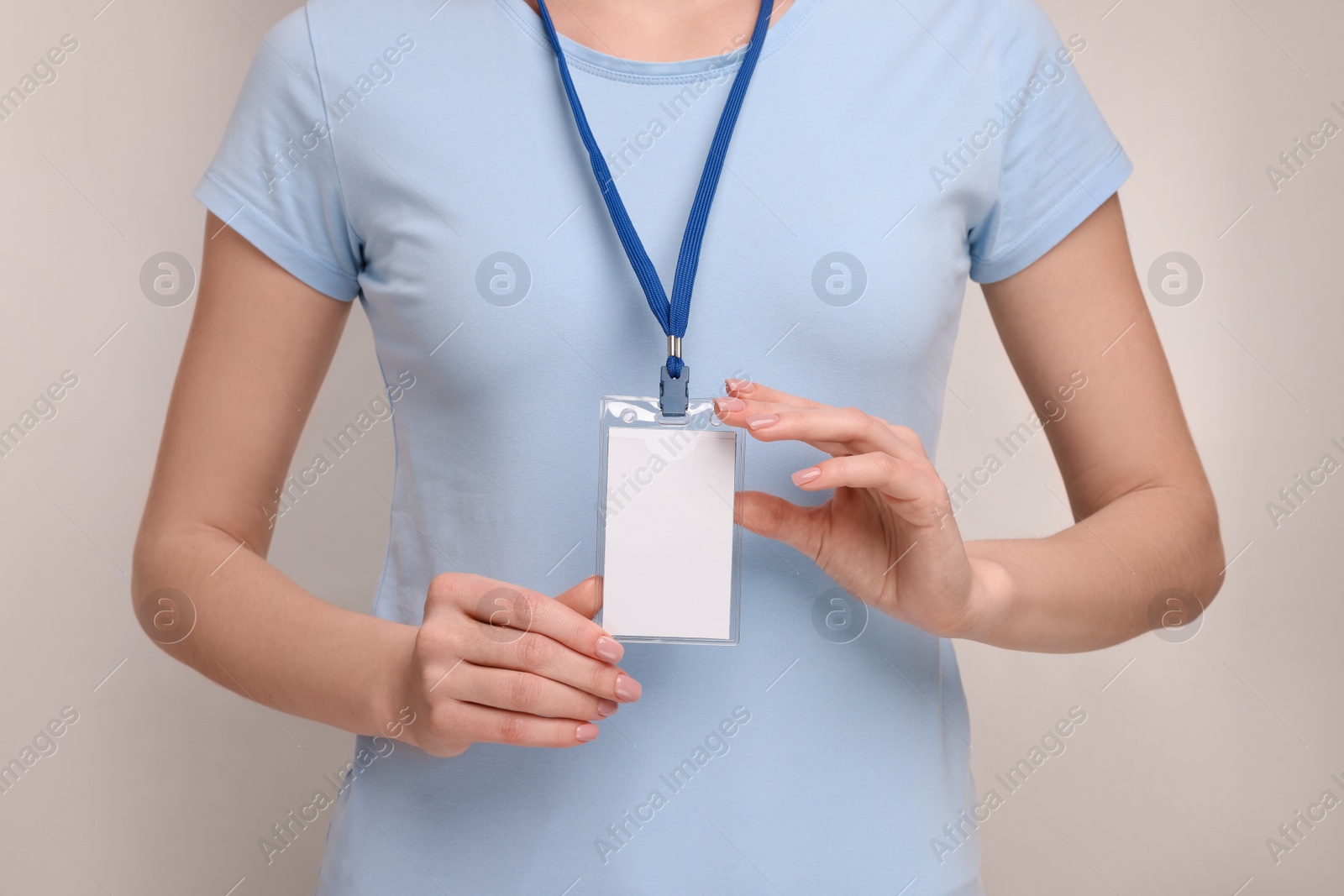 Photo of Woman with blank badge on grey background, closeup