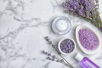 Photo of Flat lay composition with lavender flowers and natural cosmetic products on marble background