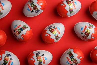 Photo of Sveti Vlas, Bulgaria - June 27, 2023: Kinder Surprise Eggs on red background, flat lay