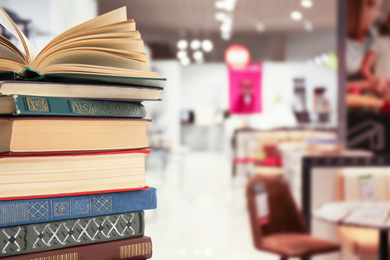 Image of Collection of different books against blurred background, space for text