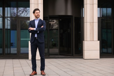 Happy real estate agent outdoors. Space for text
