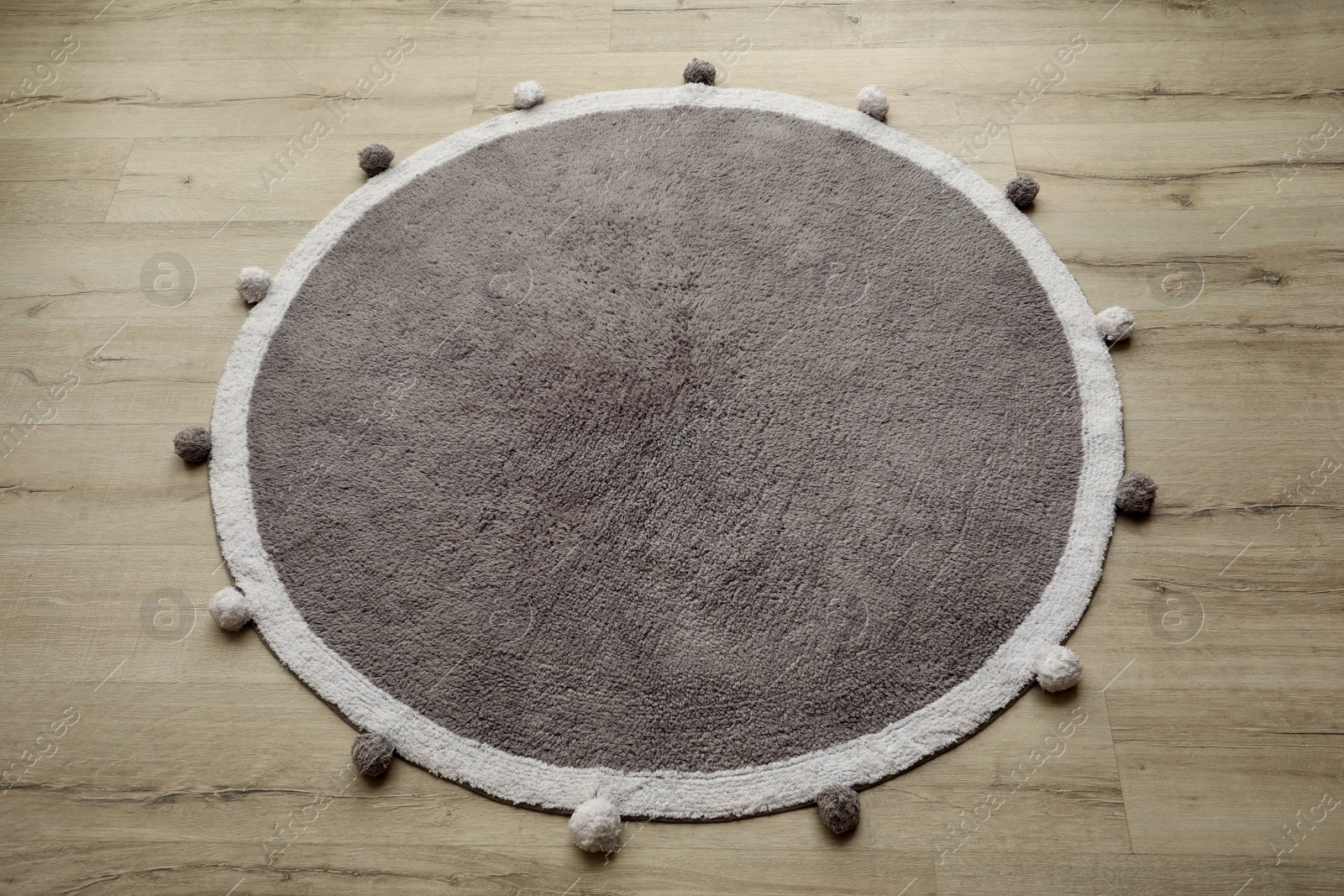Photo of Stylish soft rug on floor, above view
