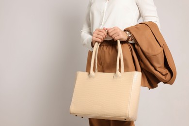 Photo of Young woman with stylish bag on white background, closeup