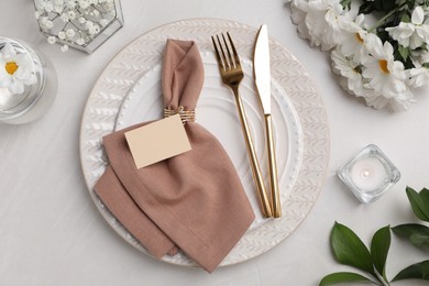 Photo of Elegant festive setting with floral decor on white table, flat lay