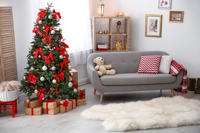 Photo of Room interior with beautiful Christmas tree and gifts