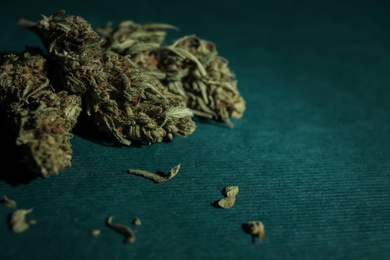 Photo of Dried hemp buds on color background, closeup. Space for text