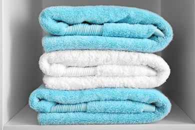 Photo of Stack of clean towels on shelf