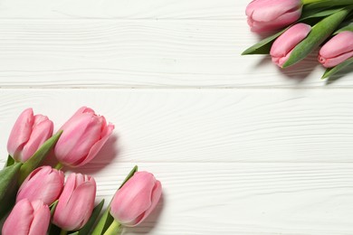 Photo of Happy Mother's Day. Beautiful pink tulips on white wooden table, flat lay. Space for text