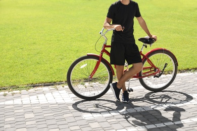 Photo of Man with bike outdoors on sunny day, space for text
