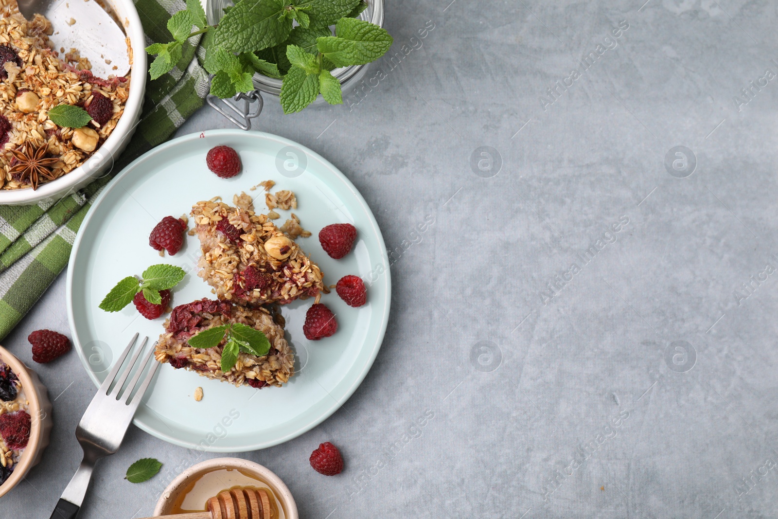 Tasty baked oatmeal with berries served on light grey table, flat lay. Space for text Photo of Tasty baked oatmeal with berries served on light grey table, flat lay. Space for text