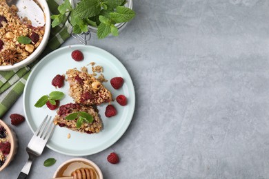 Photo of Tasty baked oatmeal with berries served on light grey table, flat lay. Space for text