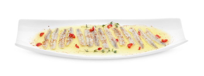 Photo of Tasty pickled anchovies with spices isolated on white